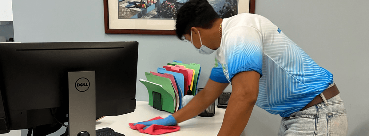 person cleaning office desk